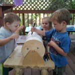 Oscar, Ruby, and Reed on the lathe