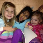 Eliana, Nerissa and Ruby reading in the bear cave